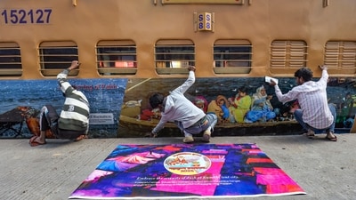 Ahmedabad: Railway workers paste posters on the exteriors of a Kumbh Mela special train, which will leave for Prayagraj, at a railway yard in Ahmedabad. (File image) (PTI) Ahmedabad: Railway workers paste posters on the exteriors of a Kumbh Mela special train, which will leave for Prayagraj, at a railway yard in Ahmedabad. (File image) (PTI)