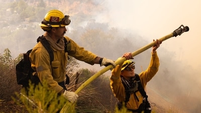 Firefighters work towards stopping the spread of six fires currently raging in Los Angeles (Benjamin Fanjoy/Bloomberg) Firefighters work towards stopping the spread of six fires currently raging in Los Angeles (Benjamin Fanjoy/Bloomberg)