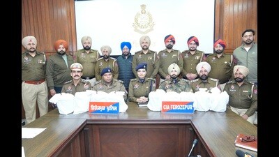 Police with the recoveries in Ferozepur on Saturday. (HT Photo)