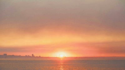 Sun rises over wildfire smoke from the Palisades Fire seen at dawn on Friday in the Pacific Palisades neighbourhood of Los Angeles, California. (AFP)