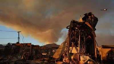 Pacific Palisades Fire: The Palisades Fire continues to burn above the remains of Community United Methodist Church, with a police helicopter flying past as wildfires cause damage and loss through Los Angeles County on January 10, 2025 in Pacific Palisades, California. (Mario Tama/Getty Images/AFP)