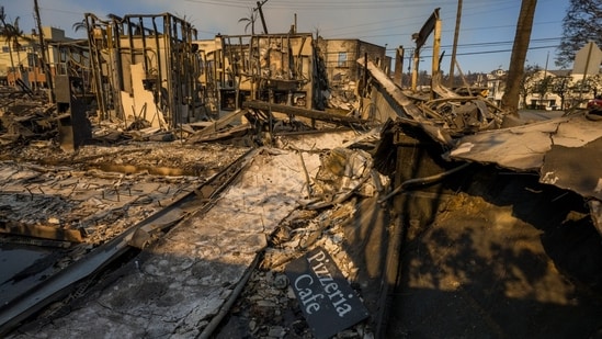 Pacific Paisades Fire: A sign for a pizzeria on the charred remains of a cafe following the Palisades Fire in the Pacific Palisades area of Los Angeles, California, US, on Friday, Jan. 10, 2025.&nbsp;(Michael Nigro/Bloomberg)
