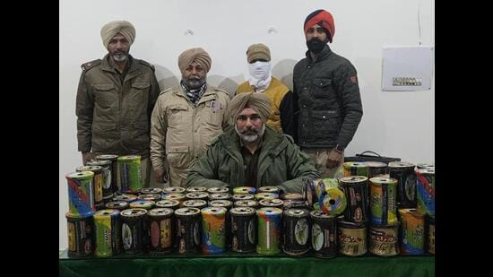 The seized plastic string spools and the arrested accused at the Focal Point police station in Ludhiana on Saturday. (HT Photo)