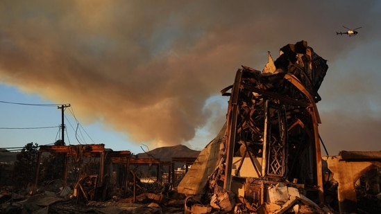 Pacific Palisades Fire: The Palisades Fire continues to burn above the remains of Community United Methodist Church, with a police helicopter flying past as wildfires cause damage and loss through Los Angeles County on January 10, 2025 in Pacific Palisades, California.(Mario Tama/Getty Images/AFP)