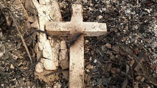 Pacific Palisades Fire: A cross rests in the remains of Community United Methodist Church, which was destroyed by the Palisades Fire, as wildfires cause damage and loss through Los Angeles County on January 10, 2025 in Pacific Palisades, California.(Mario Tama/Getty Images/AFP)