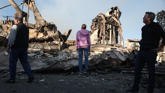 Pacific Palisades Fire: Rev. John Shaver (R) looks on while visiting the remains of Community United Methodist Church, where he is pastor, as wildfires cause damage and loss through Los Angeles County on January 10, 2025 in Pacific Palisades, California.(Mario Tama/Getty Images/AFP)