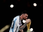 Argentina's Lionel Messi celebrates with the trophy after winning the World Cup.