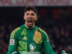 Manchester United's Altay Bayindir celebrates after he saves a penalty from Arsenal's Kai Havertz during the shoot-out