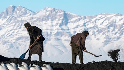 Afghan labourers shovel coal onto a truck bound for Pakistan, at a coal yard near snow-laden mountains on the outskirts of Kabul on January 6. (AFP) Afghan labourers shovel coal onto a truck bound for Pakistan, at a coal yard near snow-laden mountains on the outskirts of Kabul on January 6. (AFP)