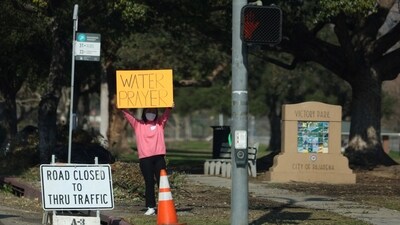 A person holds a sign asking for support for those affected by the Eaton Fire in Pasadena, California, U.S. Los Angeles County Sheriff Robert Luna warned residents against returning to their destroyed homes to salvage belongings, as the ash may contain dangerous materials like lead, arsenic, and asbestos. (REUTERS)
