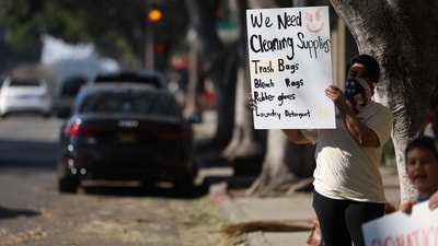 People hold signs seeking donations for those impacted by the Eaton Fire in Pasadena, California, U.S. The devastation is shocking even in a state accustomed to large-scale wildfires. Traum from the Office of Emergency Services encouraged those affected to apply online for immediate government assistance. (REUTERS)