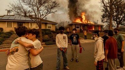 Residents embrace outside of a burning property as the Eaton Fire swept through. (AP file photo) Residents embrace outside of a burning property as the Eaton Fire swept through. (AP file photo)