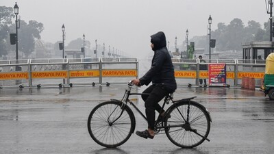 New Delhi, Jan 11 (ANI): A man passes on a bicycle at the Kartavya Path as drizzle lashes, in New Delhi on Saturday. (ANI Photo/Ishant) (Ishant ) New Delhi, Jan 11 (ANI): A man passes on a bicycle at the Kartavya Path as drizzle lashes, in New Delhi on Saturday. (ANI Photo/Ishant) (Ishant )
