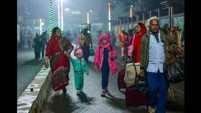 Hindu pilgrims with their belongings leave a railway station as they move towards Sangam (AFP)