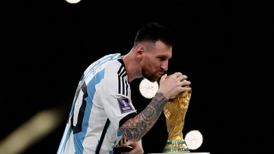 Argentina's Lionel Messi celebrates with the trophy after winning the World Cup. (REUTERS)