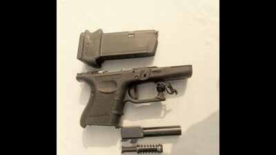 The troops recovered two packets, one with a Glock pistol with a magazine and another with suspected heroin weighing 548 grams. (HT Photo)
