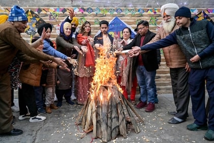 People offer puffed rice, peanuts and popcorn to a bonfire on the occasion of Lohri, the Hindu Sikh festival of spring in Amritsar. (AFP) People offer puffed rice, peanuts and popcorn to a bonfire on the occasion of Lohri, the Hindu Sikh festival of spring in Amritsar. (AFP)