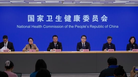 Wang Liping, second left, a researcher for the Chinese Center for Disease Control and Prevention speaks during a press briefing in Beijing, Sunday, Jan. 12, 2025. (AP)