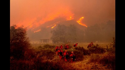The sweeping fires in California have killed 24 people, ravaged communities, and sent thousands frantically fleeing their properties, including areas dotted with celebrity homes (Noah Berger/AP) The sweeping fires in California have killed 24 people, ravaged communities, and sent thousands frantically fleeing their properties, including areas dotted with celebrity homes (Noah Berger/AP)