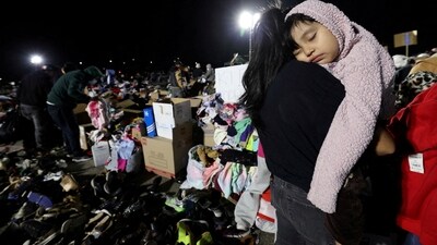 A girl lies asleep on her mom's shoulder at a distribution centre for people affected by the Eaton Fire at Santa Anita Park in Arcadia, California. Even as firefighters are battling the blazes, Governor Gavin Newsom has called for a plan to clear the area so that rebuilding can begin. (REUTERS)