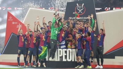 Barcelona's players celebrate with the trophy after winning the Spanish Super Cup (AFP)
