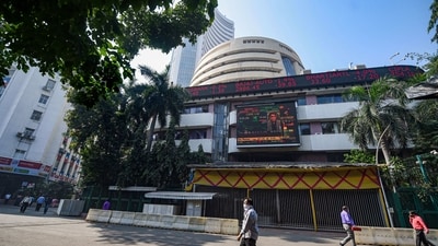 Stock market crash: People walk near the facade of BSE building in Mumbai. (PTI) Stock market crash: People walk near the facade of BSE building in Mumbai. (PTI)