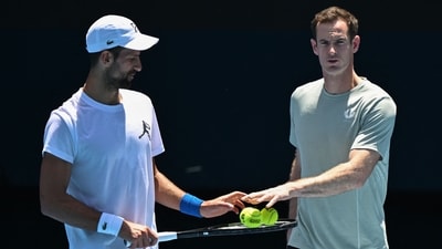 Serbia's Novak Djokovic (L) and his coach Andy Murray talk during a practice session ahead of the Australian Open tennis tournament in Melbourne. (AFP)