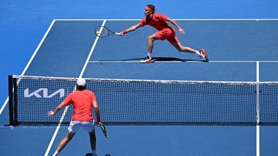 Greece's Stefanos Tsitsipas (top) hits a return against USA's Alex Michelsen during their men's singles match on day two of the Australian Open tennis tournament in Melbourne. (AFP) Greece's Stefanos Tsitsipas (top) hits a return against USA's Alex Michelsen during their men's singles match on day two of the Australian Open tennis tournament in Melbourne. (AFP)