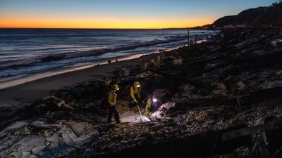 Firefighters from Woodland Hills search for hotspots in a burned home at Pacific Coast Highway on January 12, 2025, in the Pacific Palisades neighbourhood of Los Angeles, At least 16 people have died and over 100,000 people are still under evacuation orders. Over 12,000 structures have been destroyed in the fires. (Getty Images via AFP) Firefighters from Woodland Hills search for hotspots in a burned home at Pacific Coast Highway on January 12, 2025, in the Pacific Palisades neighbourhood of Los Angeles, At least 16 people have died and over 100,000 people are still under evacuation orders. Over 12,000 structures have been destroyed in the fires. (Getty Images via AFP)