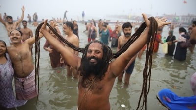This year’s Maha Kumbh, the largest spiritual gathering globally, is made even more special by a rare celestial alignment that occurs once in 144 years. In the picture, devotees can be seen taking a dip in Triveni Sangam early on Monday morning. (HT Photo)