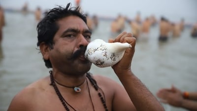 The spiritual event, held once every 12 years, is expected to attract over 45 crore devotees and will conclude on February 26. In the picture, a devotee takes a holy dip in the Sangam on Monday. (HT Photo)