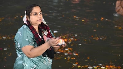 A woman takes a holy dip at Triveni Sangam during Mahakumbh in Prayagraj on Monday. (HT Photo)