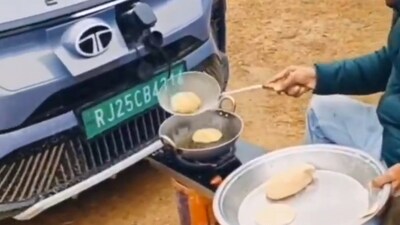 The viral video shows a man sitting on a chair in front of a car and frying kachoris in a pot. (X/@Captainknows2) The viral video shows a man sitting on a chair in front of a car and frying kachoris in a pot. (X/@Captainknows2)