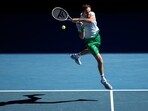Daniil Medvedev of Russia plays a backhand return to Kasidit Samrej of Thailand during their first round match at the Australian Open tennis championship in Melbourne, Australia, Tuesday, Jan. 14, 2025. (AP Photo/Ng Han Guan)