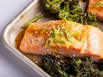 This image released by Milk Street shows a recipe for honey-miso salmon and broccolini traybake.(Milk Street via AP)