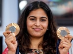 Paris Olympics bronze medallist shooter Manu Bhaker poses with her medals. Paris Olympics bronze medallist shooter Manu Bhaker poses with her medals.