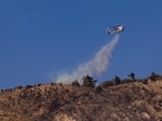 US officials warned "dangerous and strong" winds were set to push deadly wildfires further through Los Angeles residential areas January 12 as firefighters struggled to make progress against the flames. (Photo by ETIENNE LAURENT / AFP) US officials warned "dangerous and strong" winds were set to push deadly wildfires further through Los Angeles residential areas January 12 as firefighters struggled to make progress against the flames. (Photo by ETIENNE LAURENT / AFP)