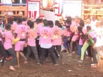 Participants at Avaniyapuram Jallikattu event look at the entry gate as they await the bull's entry. 