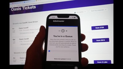 A person in a queue to access the Ticketmaster website on their phone, with the StubHub website in the background, detailing information about Oasis concert tickets for sale, in London (Yui Mok/PA) A person in a queue to access the Ticketmaster website on their phone, with the StubHub website in the background, detailing information about Oasis concert tickets for sale, in London (Yui Mok/PA)