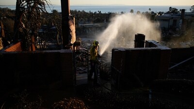 Apple Valley Fire District firefighter Wyatt Cortez hoses down hotspots at a home destroyed by the Palisades Fire in the Pacific Palisades neighborhood of Los Angeles, Monday, Jan. 13, 2025. (AP Photo/John Locher) (AP) Apple Valley Fire District firefighter Wyatt Cortez hoses down hotspots at a home destroyed by the Palisades Fire in the Pacific Palisades neighborhood of Los Angeles, Monday, Jan. 13, 2025. (AP Photo/John Locher) (AP)