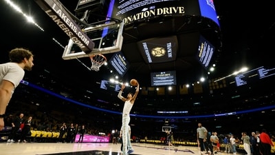 Los Angeles wildfires: San Antonio Spurs center Victor Wembanyama, center, warms up with signs announcing the Los Angeles Lakers donation drive for California wildfires victims before an NBA basketball game Monday, Jan. 13, 2025, in Los Angeles. (Kevork Djansezian/AP) Los Angeles wildfires: San Antonio Spurs center Victor Wembanyama, center, warms up with signs announcing the Los Angeles Lakers donation drive for California wildfires victims before an NBA basketball game Monday, Jan. 13, 2025, in Los Angeles. (Kevork Djansezian/AP)
