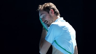 Russia's Daniil Medvedev wipes his face between the games against Thailand's Kasidit Samrej during their men's singles match on day three of the Australian Open tennis tournament in Melbourne (AFP)