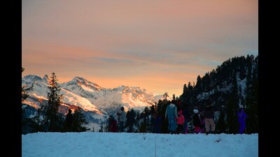 Tourists enjoying a sunset in Manali on Tuesday. (Aqil Khan/HT)