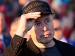 Tesla and SpaceX CEO Elon Musk listens as Republican presidential nominee former President Donald Trump speaks at a campaign event at the Butler Farm Show, on Oct. 5, 2024, in Butler, Pa.
