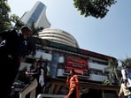 People walk past the Bombay Stock Exchange (BSE) building in Mumbai, India, March 9, 2020