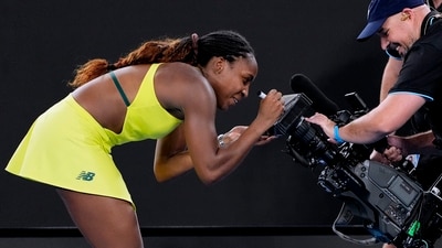 Coco Gauff of the U.S. autographs a tv camera screen after defeating Jodie Burrage of Britain in their second round match at the Australian Open tennis championship in Melbourne (AP) Coco Gauff of the U.S. autographs a tv camera screen after defeating Jodie Burrage of Britain in their second round match at the Australian Open tennis championship in Melbourne (AP)
