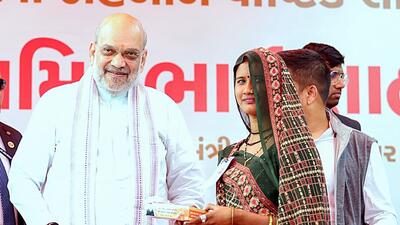 Gandhinagar, Jan 15 (ANI): Union Home Minister Amit Shah distributes Laddoo to a woman under the 'Laddoo' distribution scheme for pregnant women, at Kalol in Gandhinagar on Wednesday. (ANI Photo) (Amit Shah- X) Gandhinagar, Jan 15 (ANI): Union Home Minister Amit Shah distributes Laddoo to a woman under the 'Laddoo' distribution scheme for pregnant women, at Kalol in Gandhinagar on Wednesday. (ANI Photo) (Amit Shah- X)