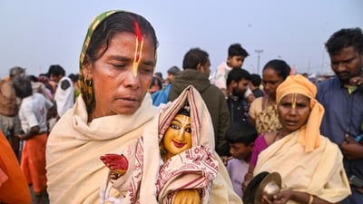 A devotee with an idol was present during the 'Makar Sankranti' festival during the ongoing Gangasagar Mela 2025. Five pilgrims from different states have so far died of old age-related ailments, an official release said. (PTI) A devotee with an idol was present during the 'Makar Sankranti' festival during the ongoing Gangasagar Mela 2025. Five pilgrims from different states have so far died of old age-related ailments, an official release said. (PTI)
