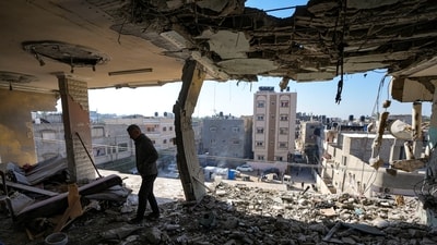 A Palestinian looks at a damaged residential building following an overnight Israeli strike in Deir al-Balah, Gaza Strip, on Jan. 8, 2025. (AP)