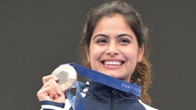 Manu Bhaker poses for a photograph with her bronze medal after finish third in the 10m air pistol women's final round. (PTI)